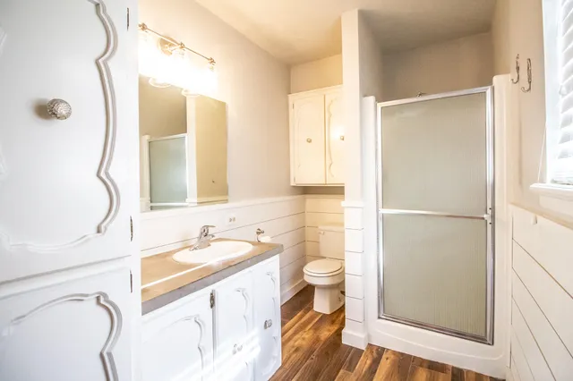 a bathroom with a sink a toilet and a mirror