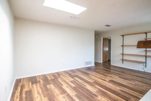 a view of an empty room and wooden floor