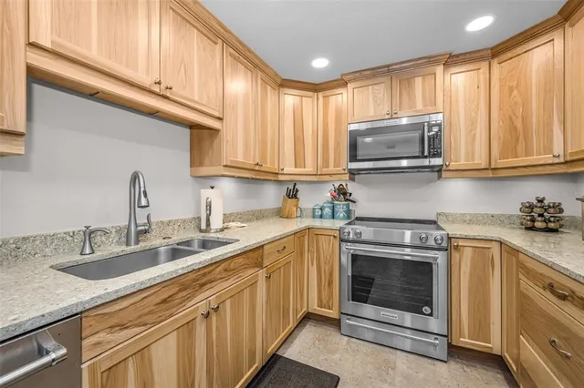 a kitchen with stainless steel appliances granite countertop a sink and cabinets