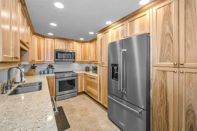 a kitchen with stainless steel appliances a refrigerator and cabinets