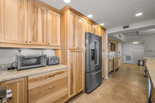 a kitchen with granite countertop sink and cabinets