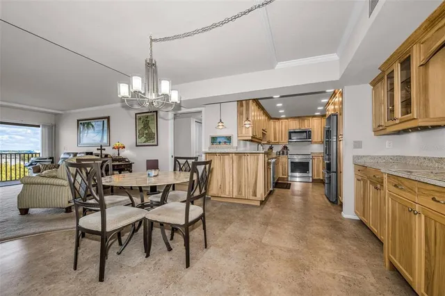 a view of a dining room with furniture and a chandelier