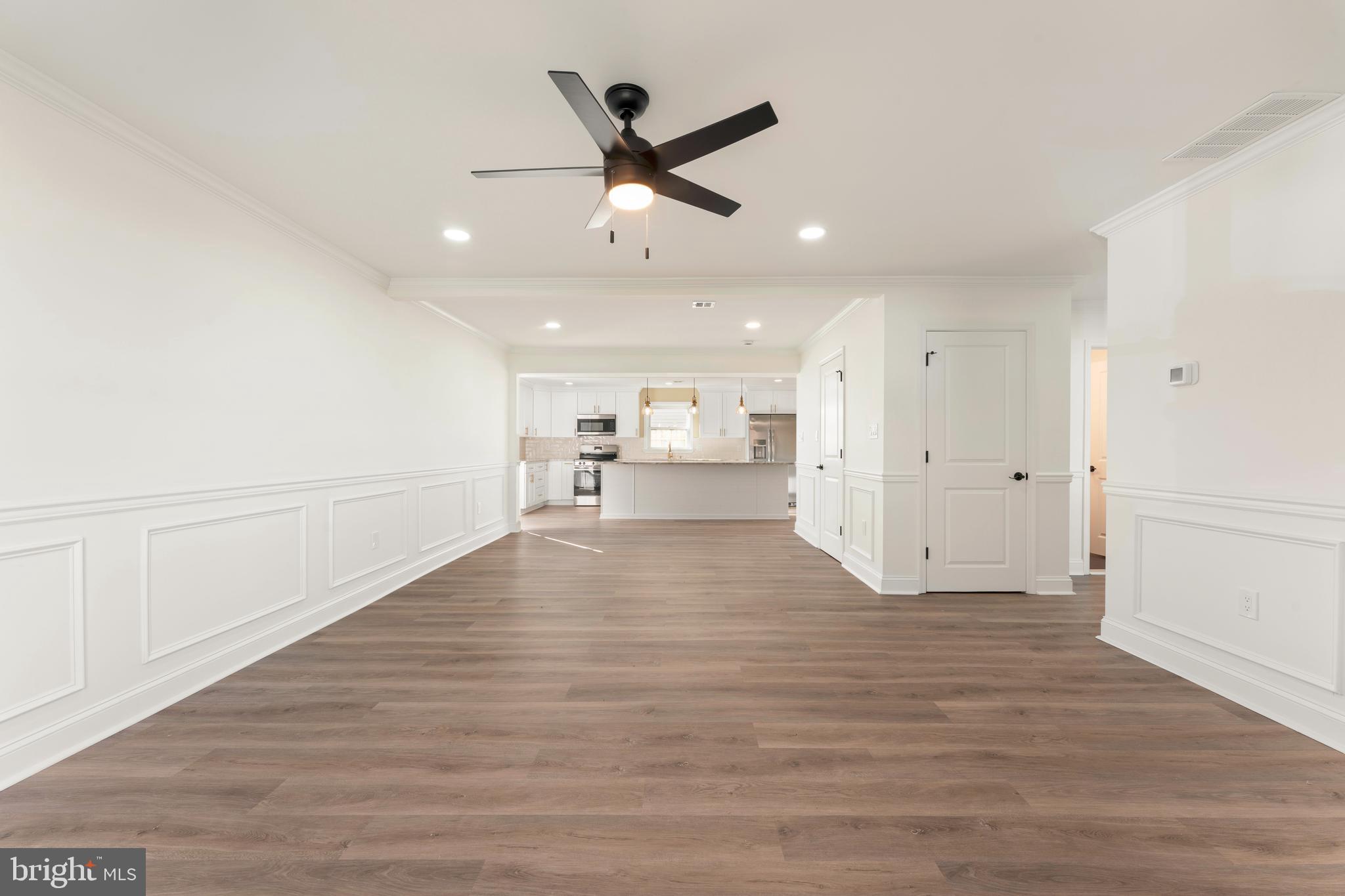 43 Petunia Road Levittown, PA 19056 - Photo 7 of 35 a view of an empty room with wooden floor and ceiling fan