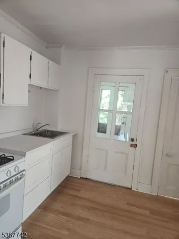 a view of a kitchen with wooden floor