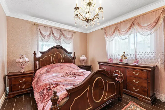 a bed with a dresser and a mirror