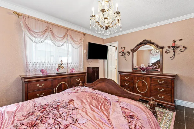 a bedroom with a bed and a television