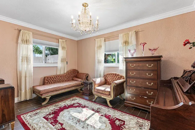 a living room with furniture and a chandelier