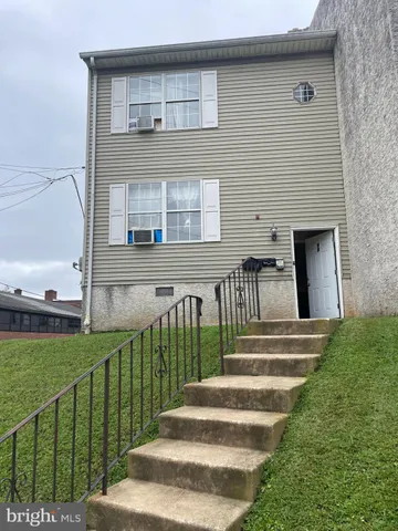 a view of a brick house with a yard