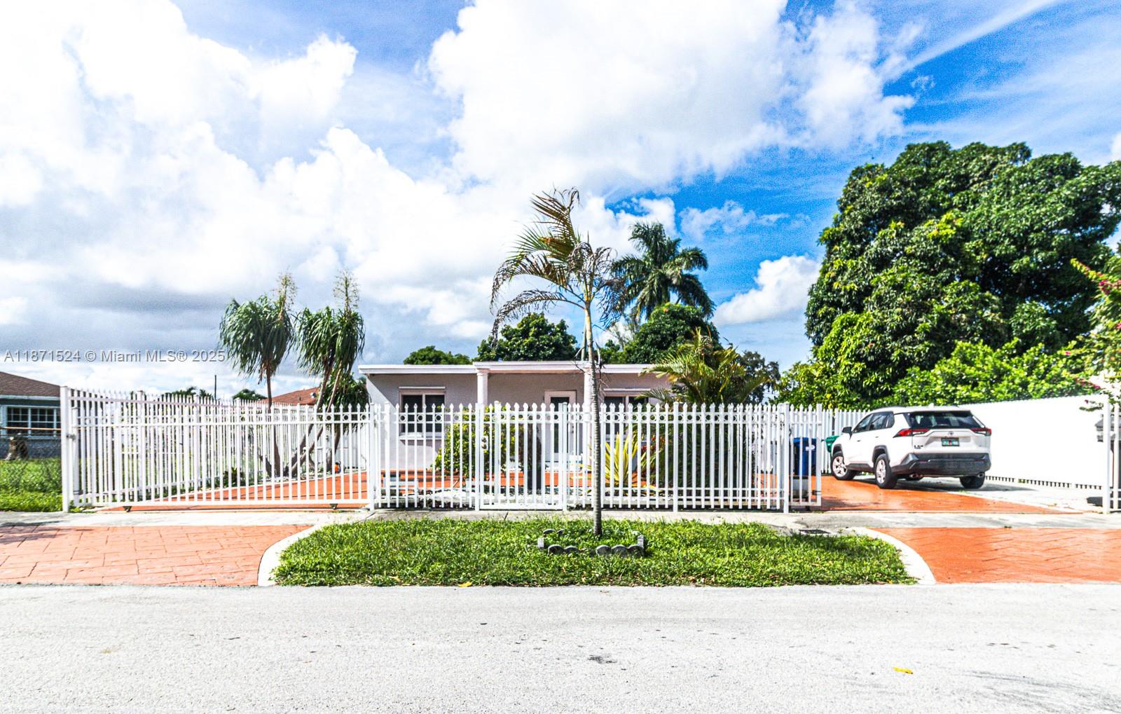 a view of a yard with plants and a fountain