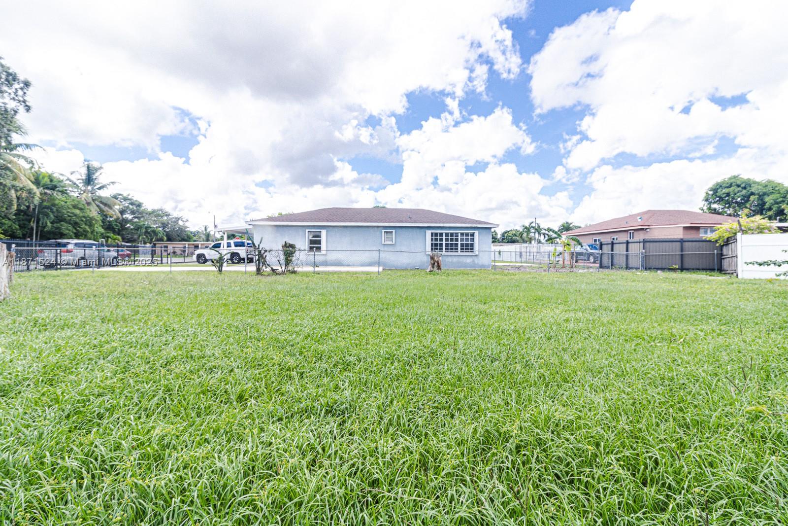 15600 Northwest 157th St Road Miami Gardens, FL 33054 - Photo 14 of 25 a view of a house with a yard and sitting area