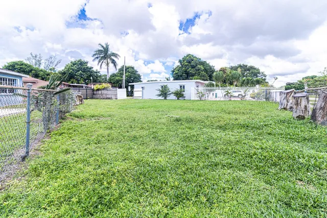 a view of a garden with a building in the background