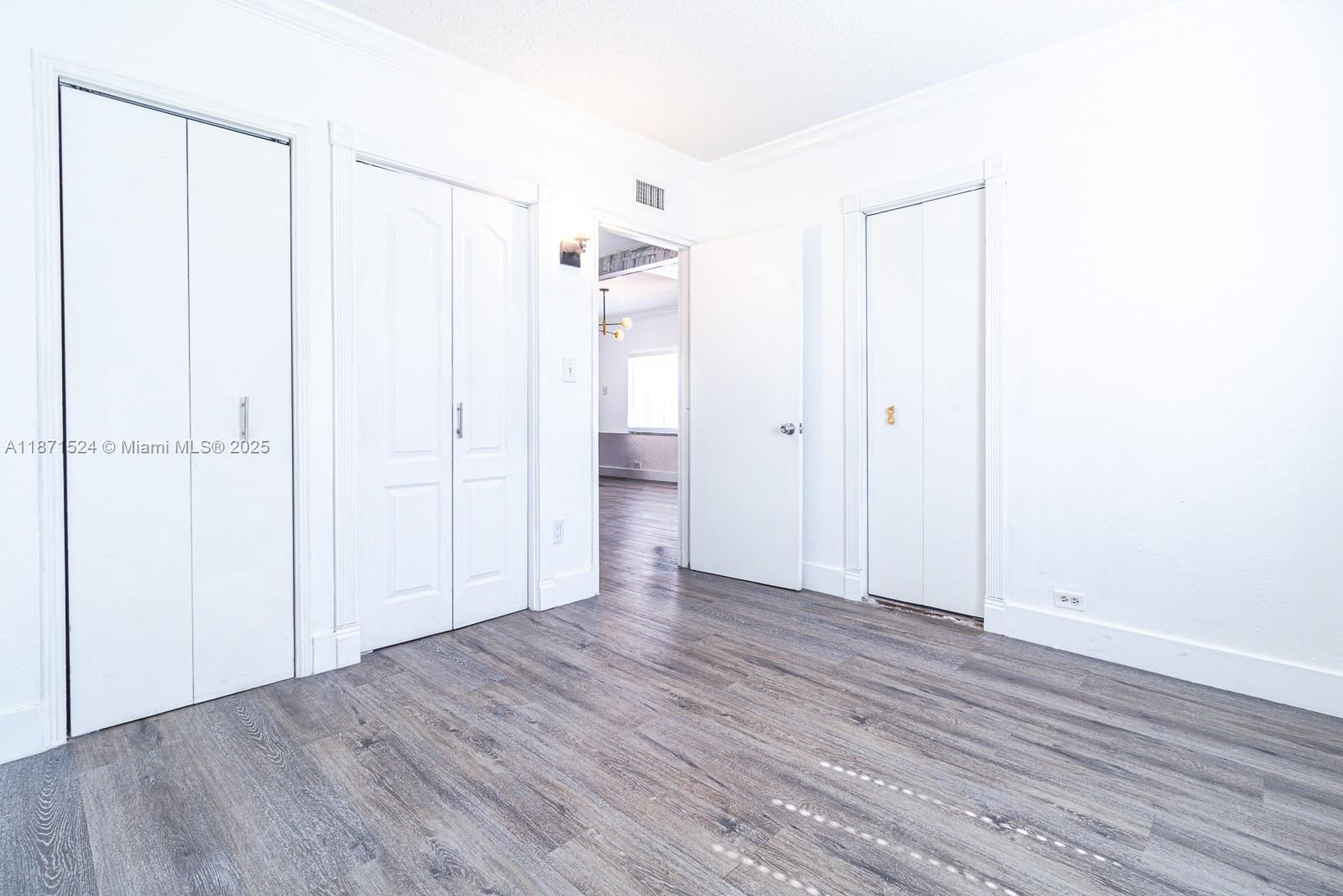 15600 Northwest 157th St Road Miami Gardens, FL 33054 - Photo 16 of 25 a view of an empty room with wooden floor