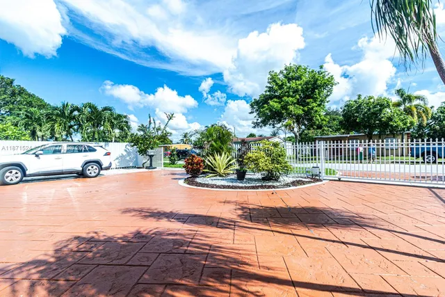 a view of a street with a car parked on the road