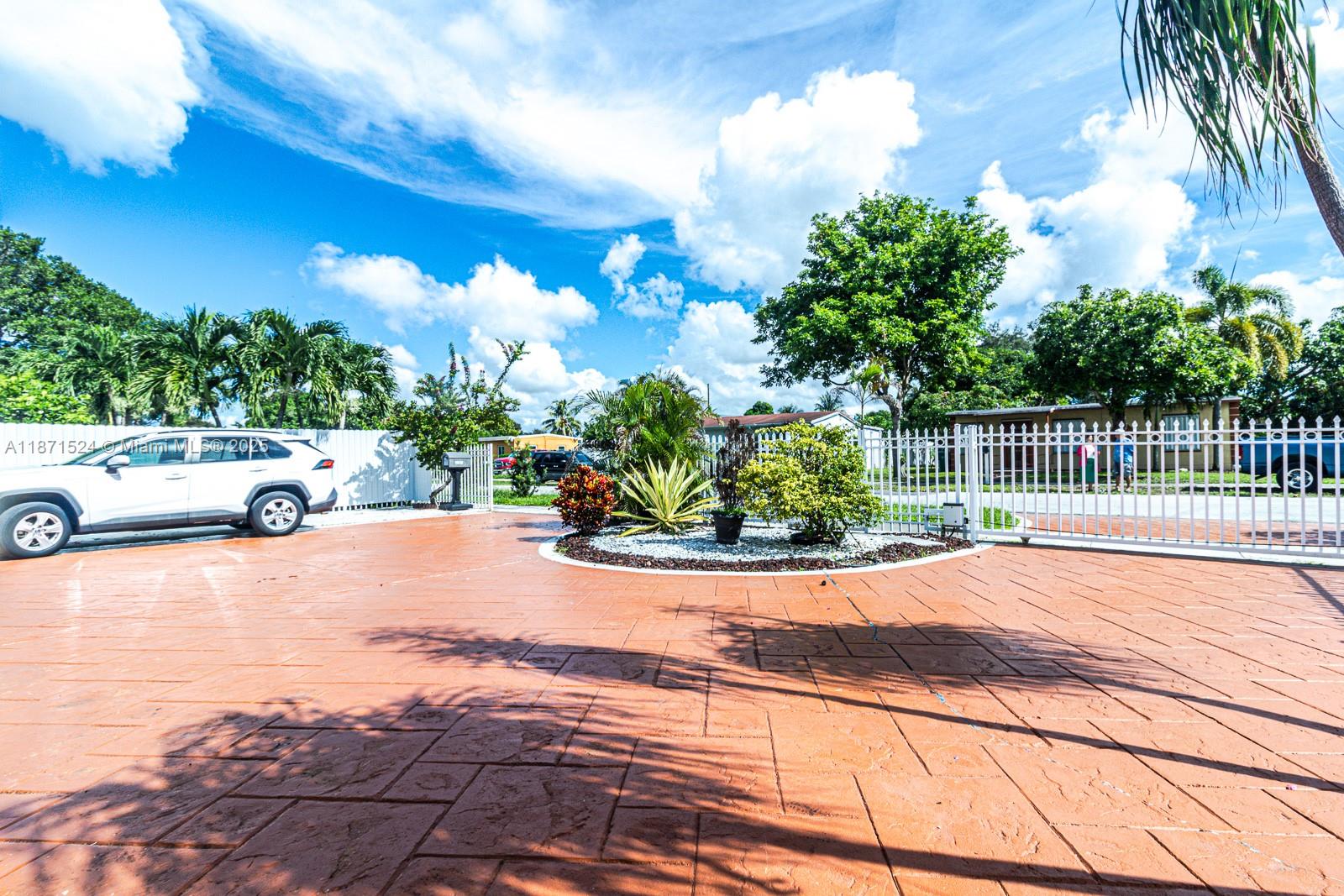 15600 Northwest 157th St Road Miami Gardens, FL 33054 - Photo 22 of 25 a view of a street with a car parked on the road