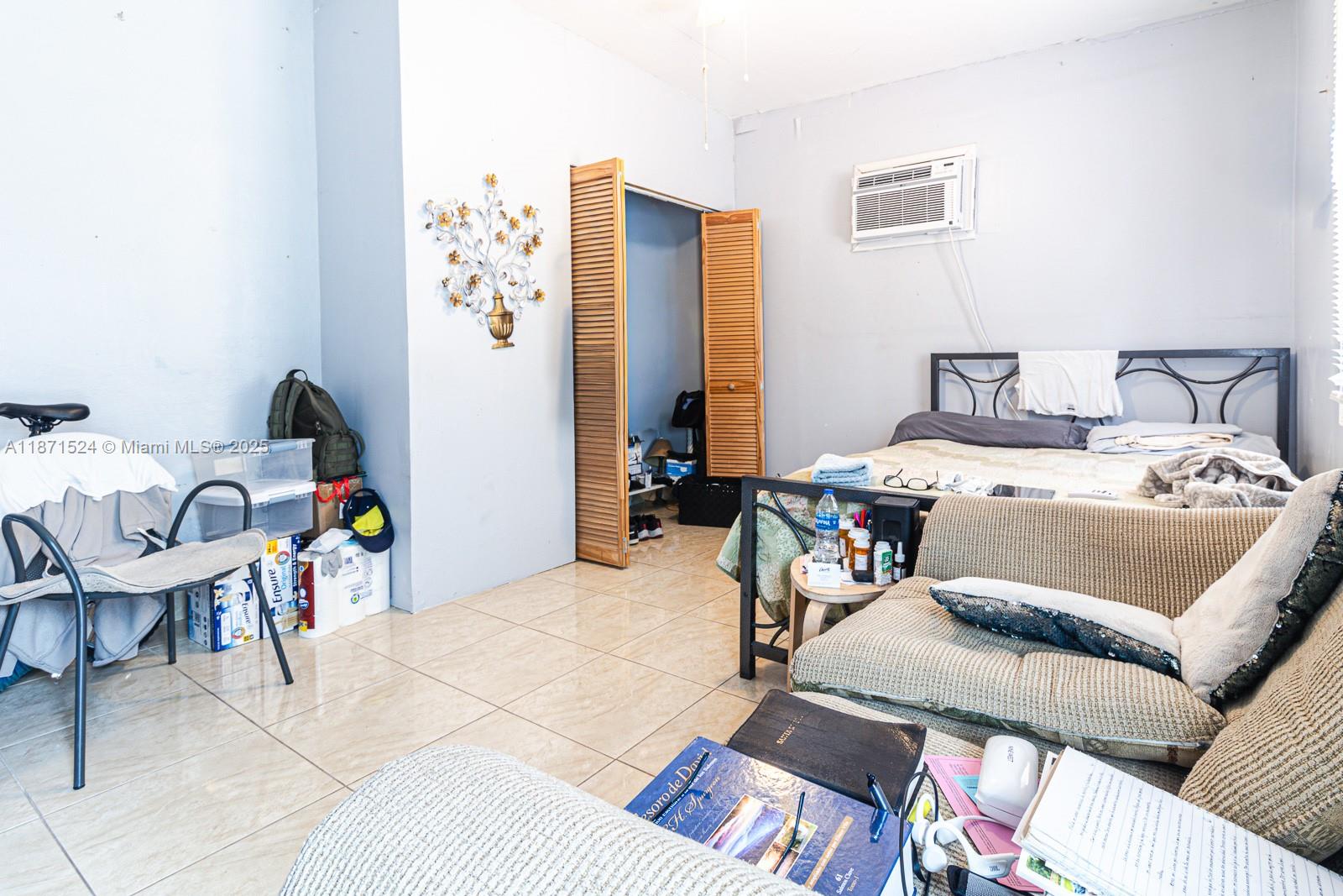 15600 Northwest 157th St Road Miami Gardens, FL 33054 - Photo 7 of 25 a bed room with a bed a couch and a window