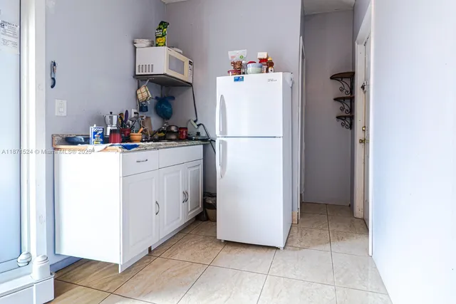 a kitchen with a refrigerator and cabinets
