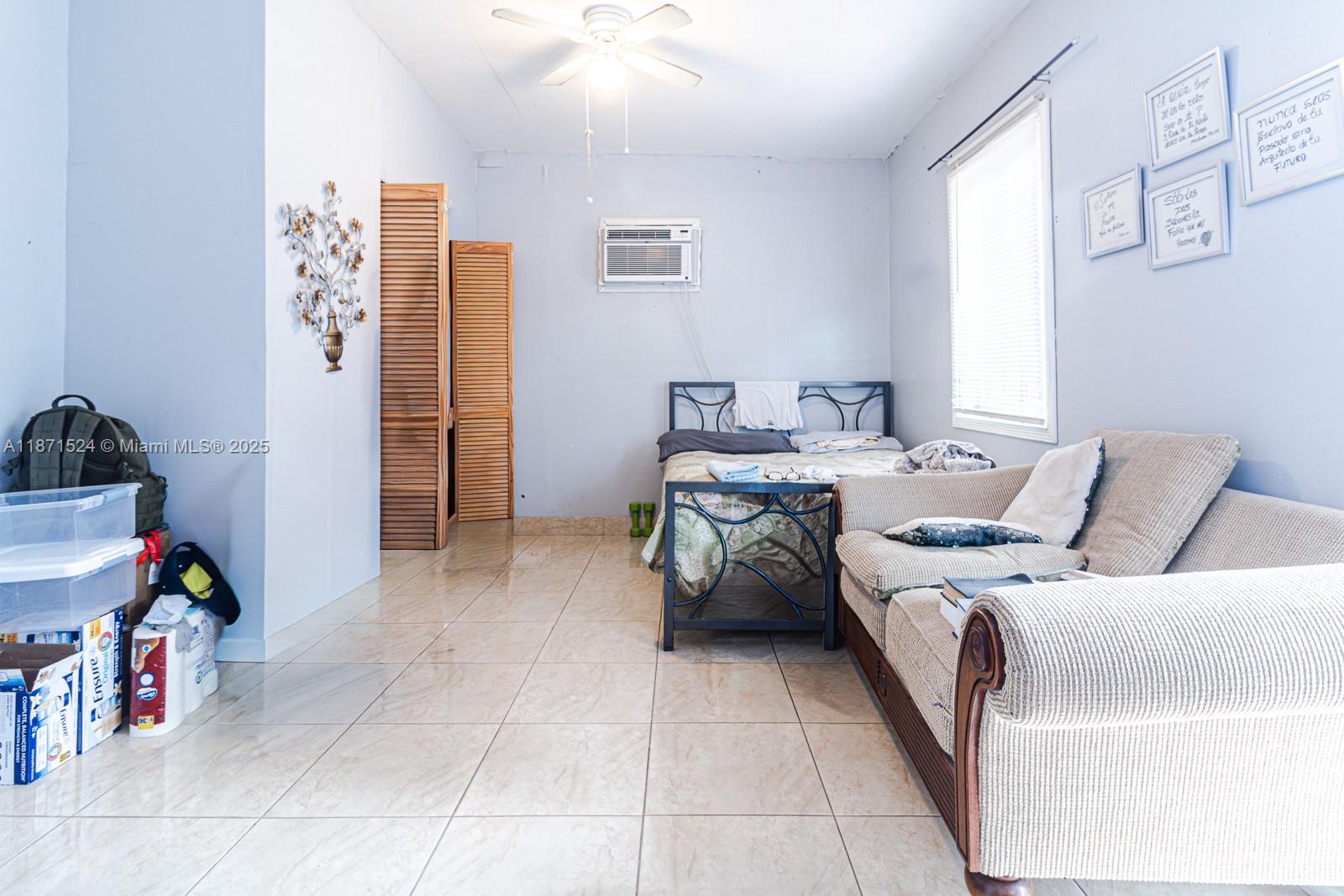 15600 Northwest 157th St Road Miami Gardens, FL 33054 - Photo 9 of 25 a bed room with a bed and a couch