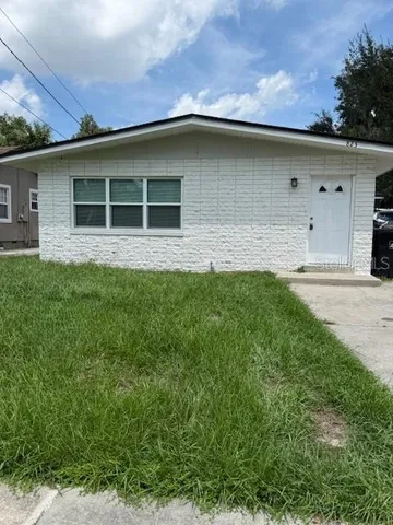 a house with lots of trees in the background