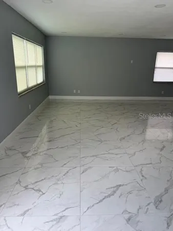 a view of an empty room and a window