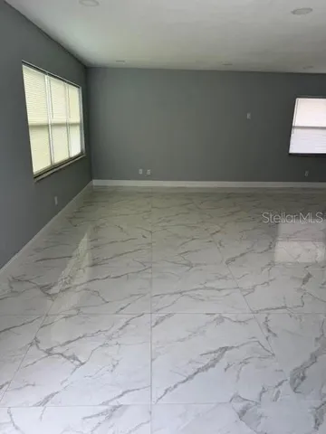 a view of an empty room and a window