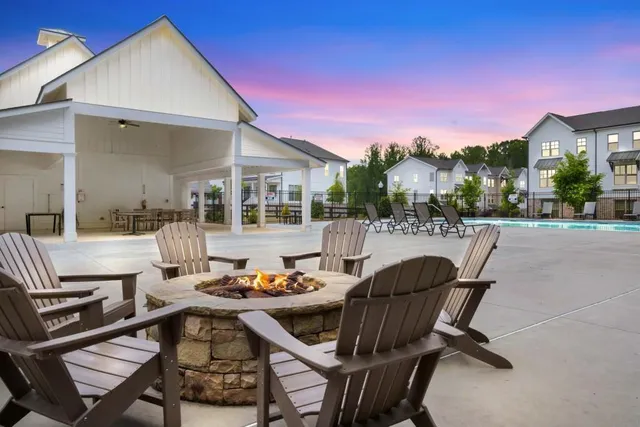 a view of a patio with dining table and chairs with wooden floor and fence