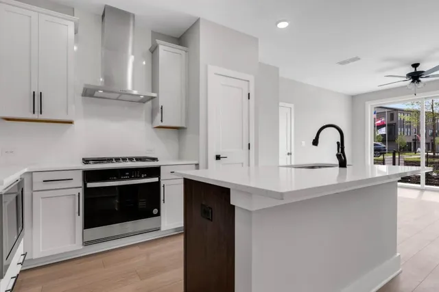 a kitchen with stainless steel appliances granite countertop a stove and a sink
