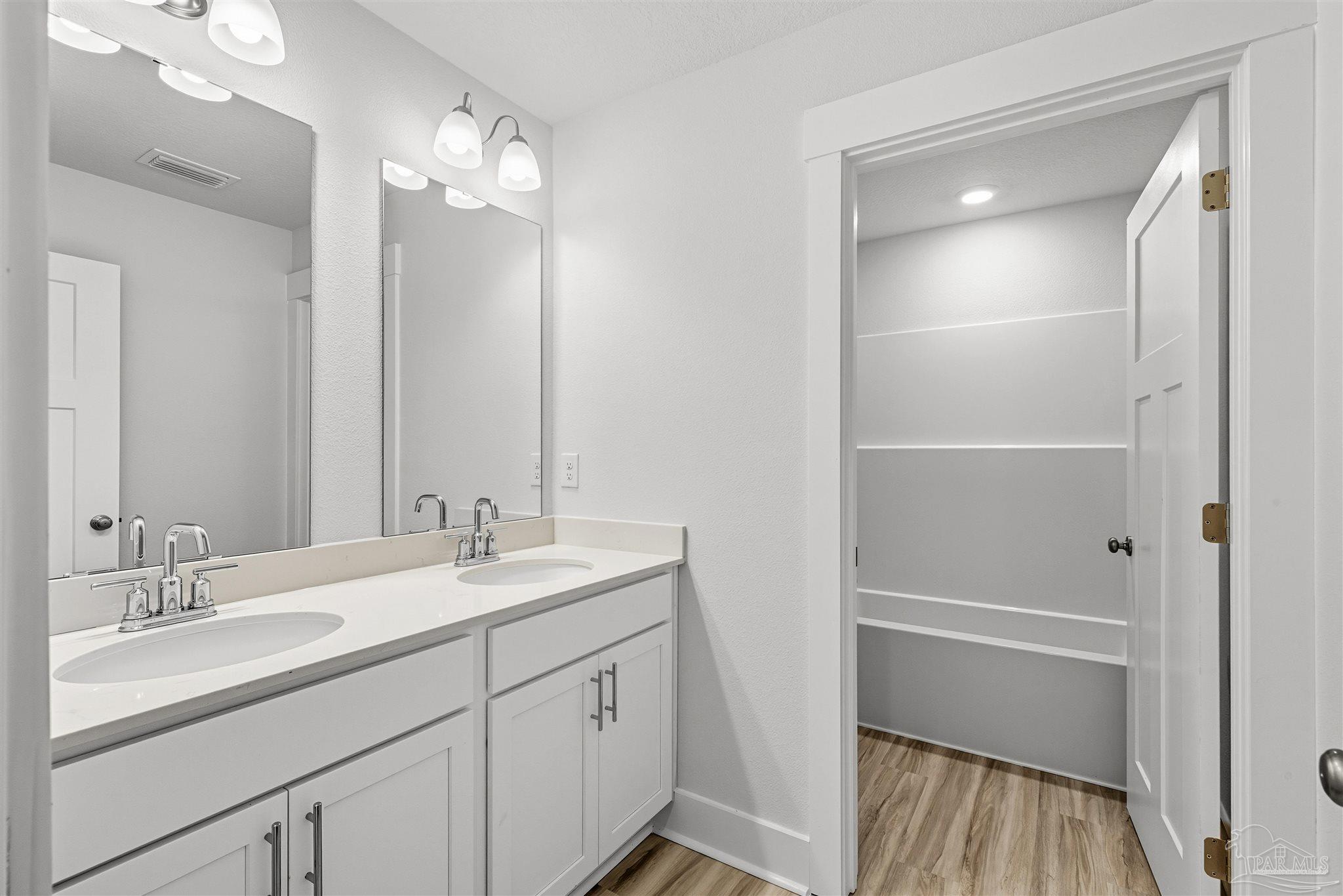 4733 Redhead Court Pace, FL 32571 - Photo 38 of 48 a bathroom with a sink vanity granite and a mirror