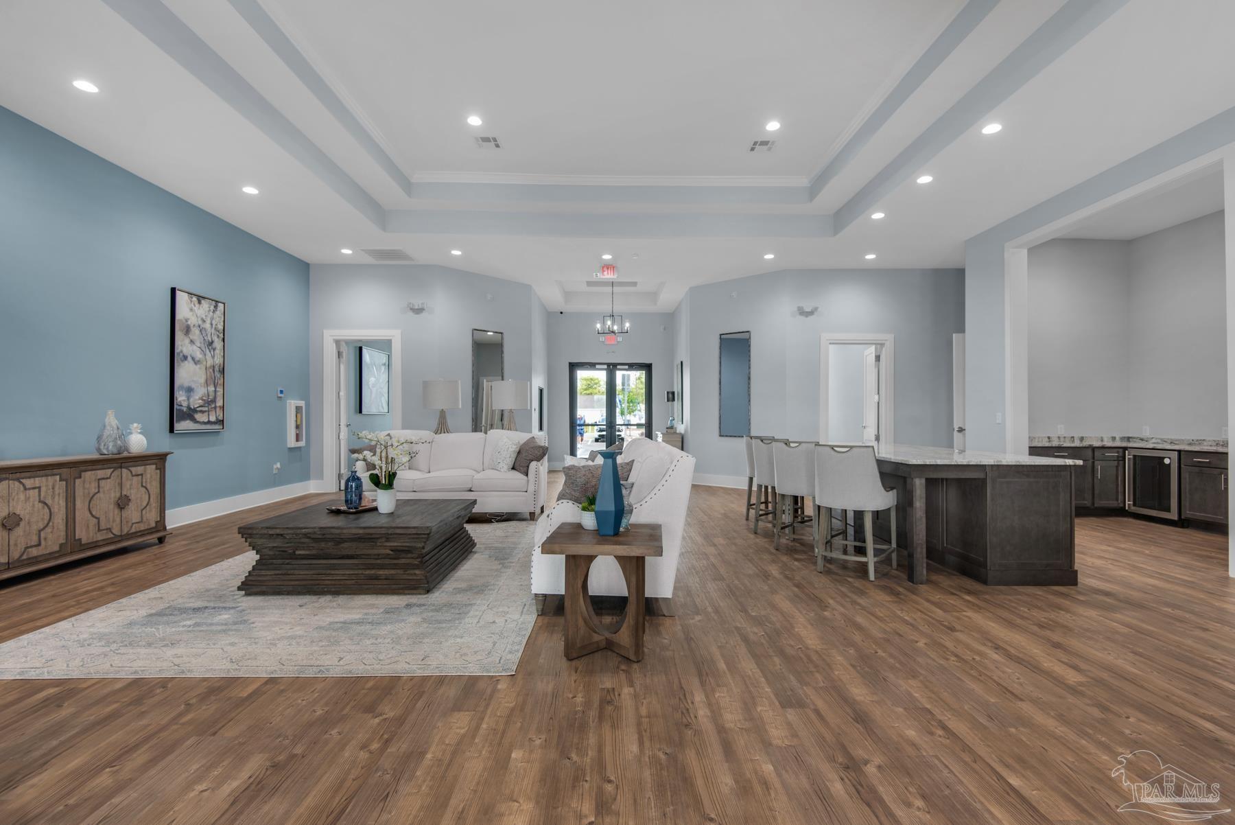4733 Redhead Court Pace, FL 32571 - Photo 40 of 48 a living room with furniture a wooden floor and kitchen view