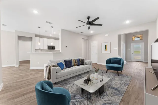 a living room with furniture and kitchen view