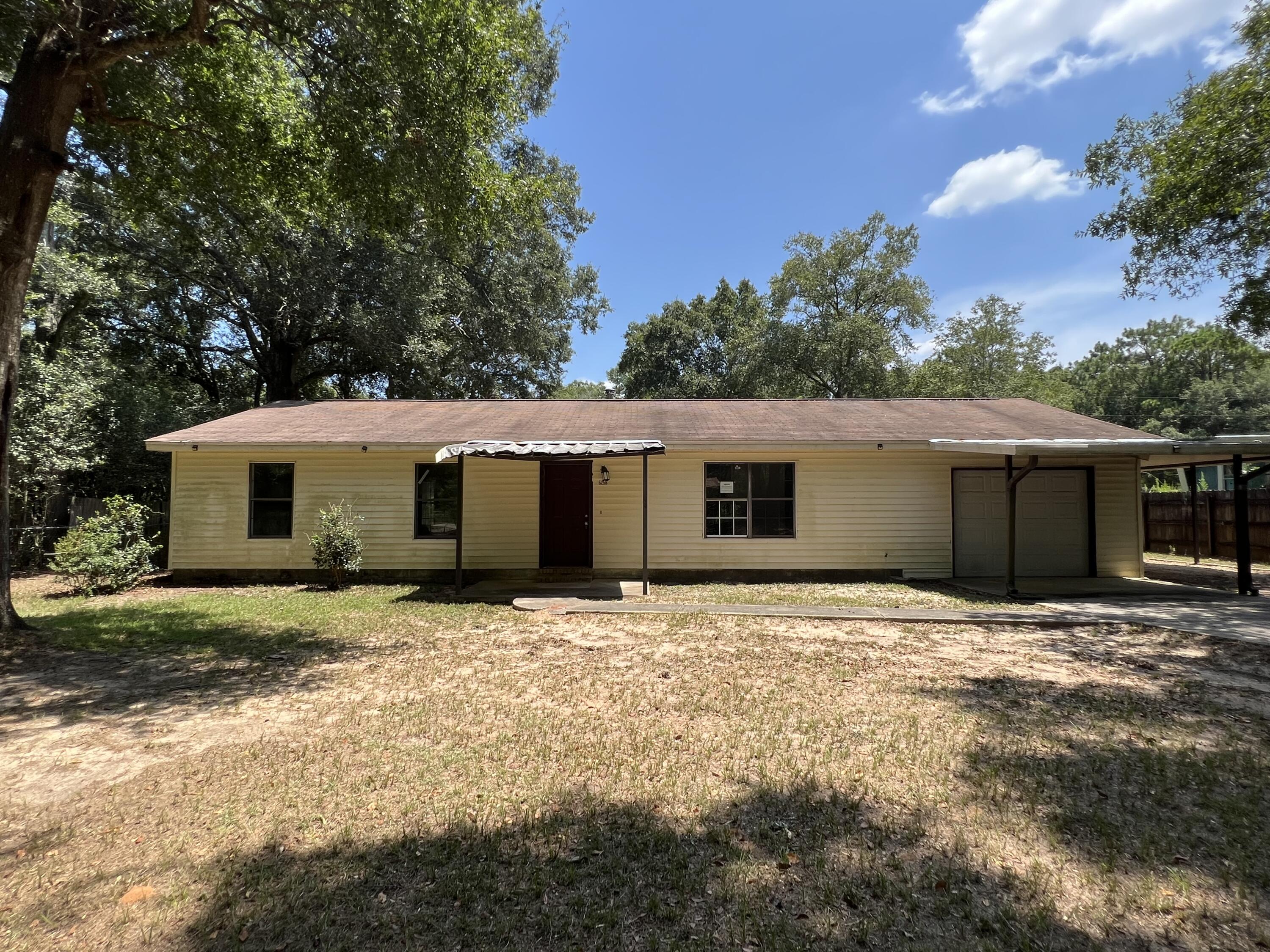 a big house with tree in front of it