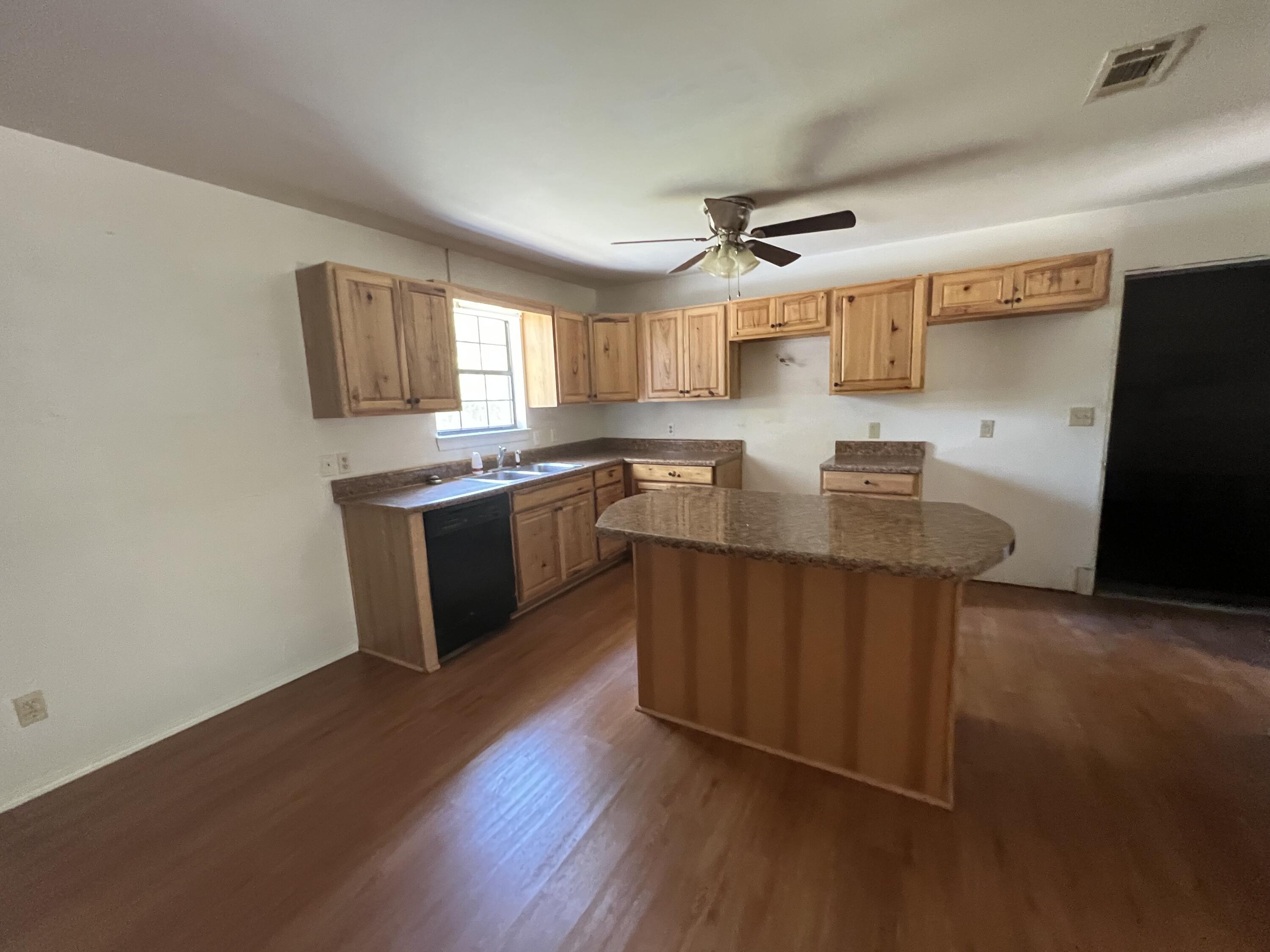 5256 Lassiter Road Milton, FL 32571 - Photo 3 of 20 a kitchen with stainless steel appliances granite countertop a sink stove and refrigerator