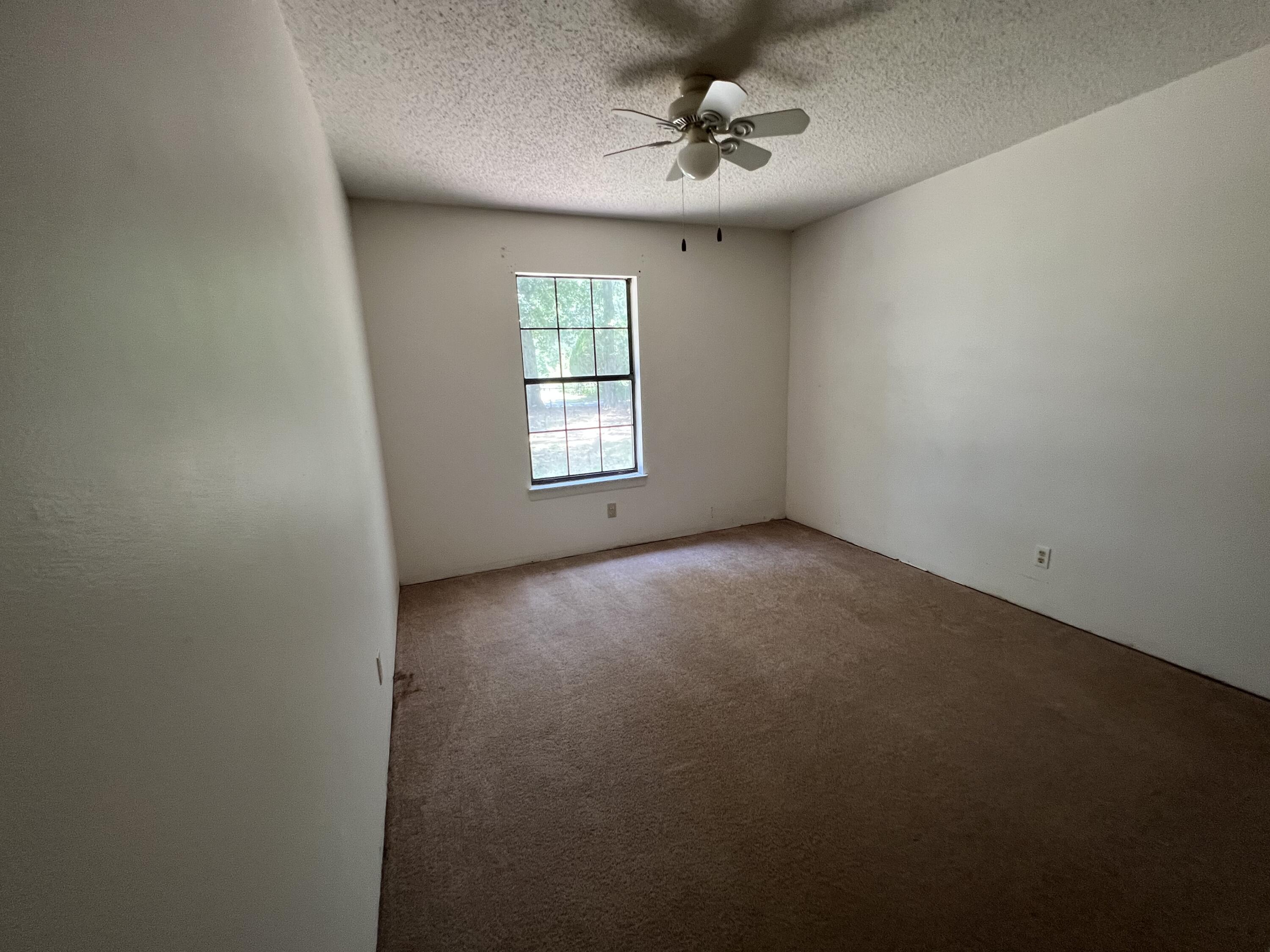 5256 Lassiter Road Milton, FL 32571 - Photo 7 of 20 a view of an empty room with a window