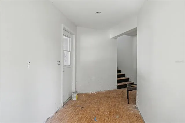 a view of room with stairs and a closet