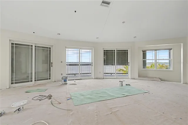 an empty room with window and mirror