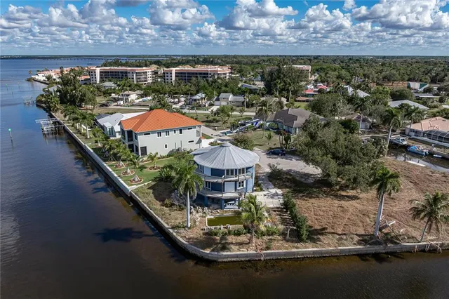 a view of a house with a yard and lake view