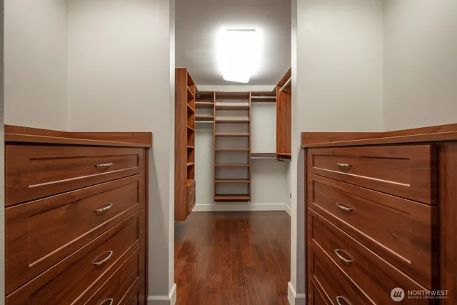 a view of walk in closet with clothes and shoes