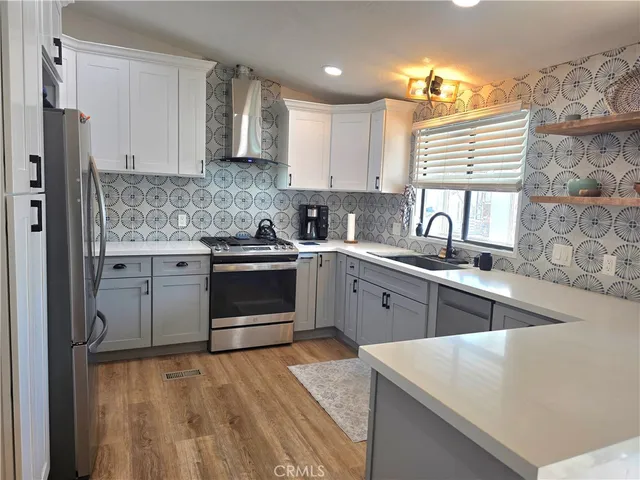 a spacious bedroom with a bed and wooden floor