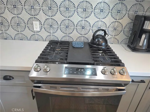 a bedroom with bed and a painting on the wall