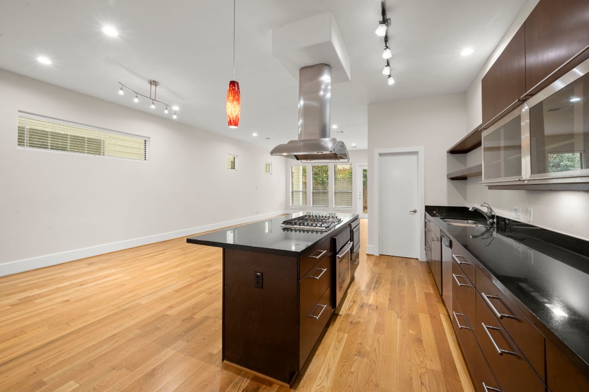 5527 Darling Street, Unit A Houston, TX 77007 - Photo 12 of 31 a kitchen with granite countertop a stove and a sink