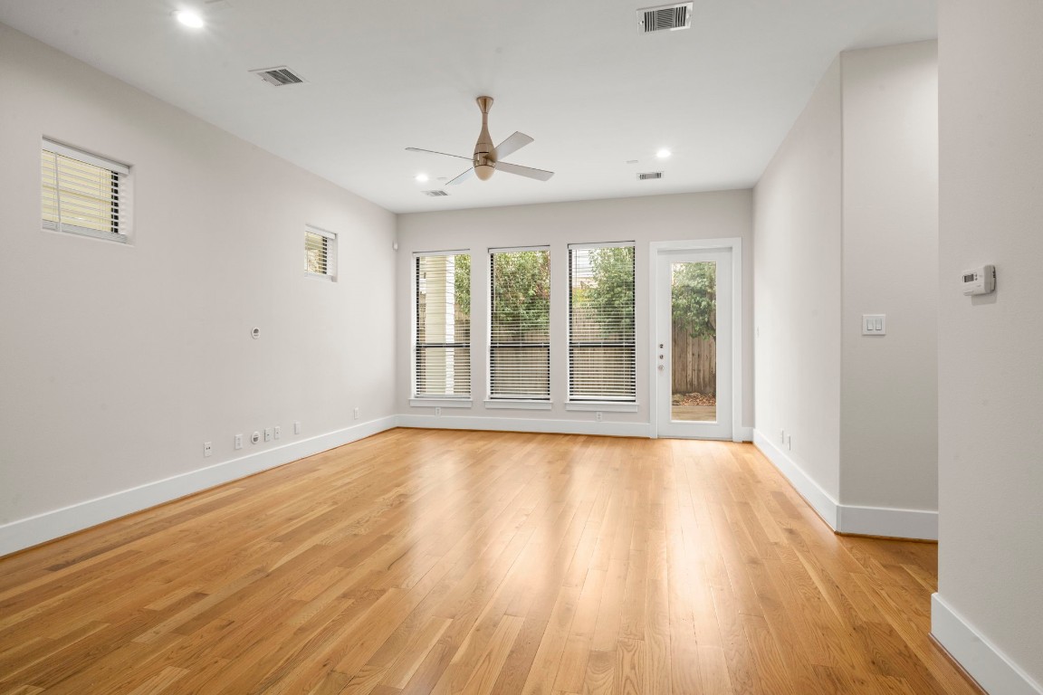 5527 Darling Street, Unit A Houston, TX 77007 - Photo 14 of 31 a view of an empty room with wooden floor and a window