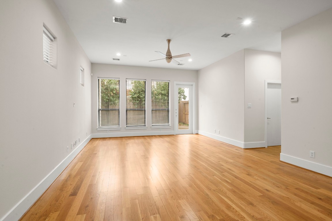 5527 Darling Street, Unit A Houston, TX 77007 - Photo 15 of 31 a view of an empty room with wooden floor and a window
