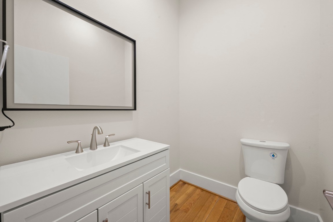 5527 Darling Street, Unit A Houston, TX 77007 - Photo 17 of 31 a bathroom with a toilet a sink and mirror
