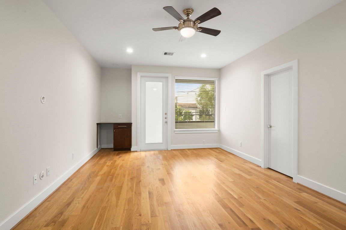 5527 Darling Street, Unit A Houston, TX 77007 - Photo 18 of 31 wooden floor in an empty room with a window