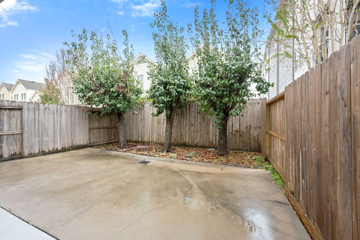 5527 Darling Street, Unit A Houston, TX 77007 - Photo 31 of 31 a wooden fence with trees in the background