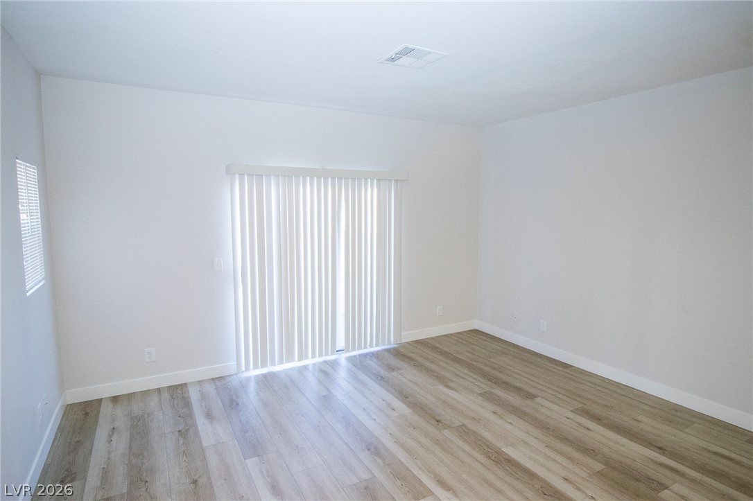 1468 Reef Ridge Court Las Vegas, NV 89128 - Photo 9 of 22 Natural light illuminates new flooring in this versatile, blank canvas living space.