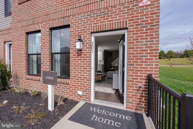 a view of a brick house next to a yard