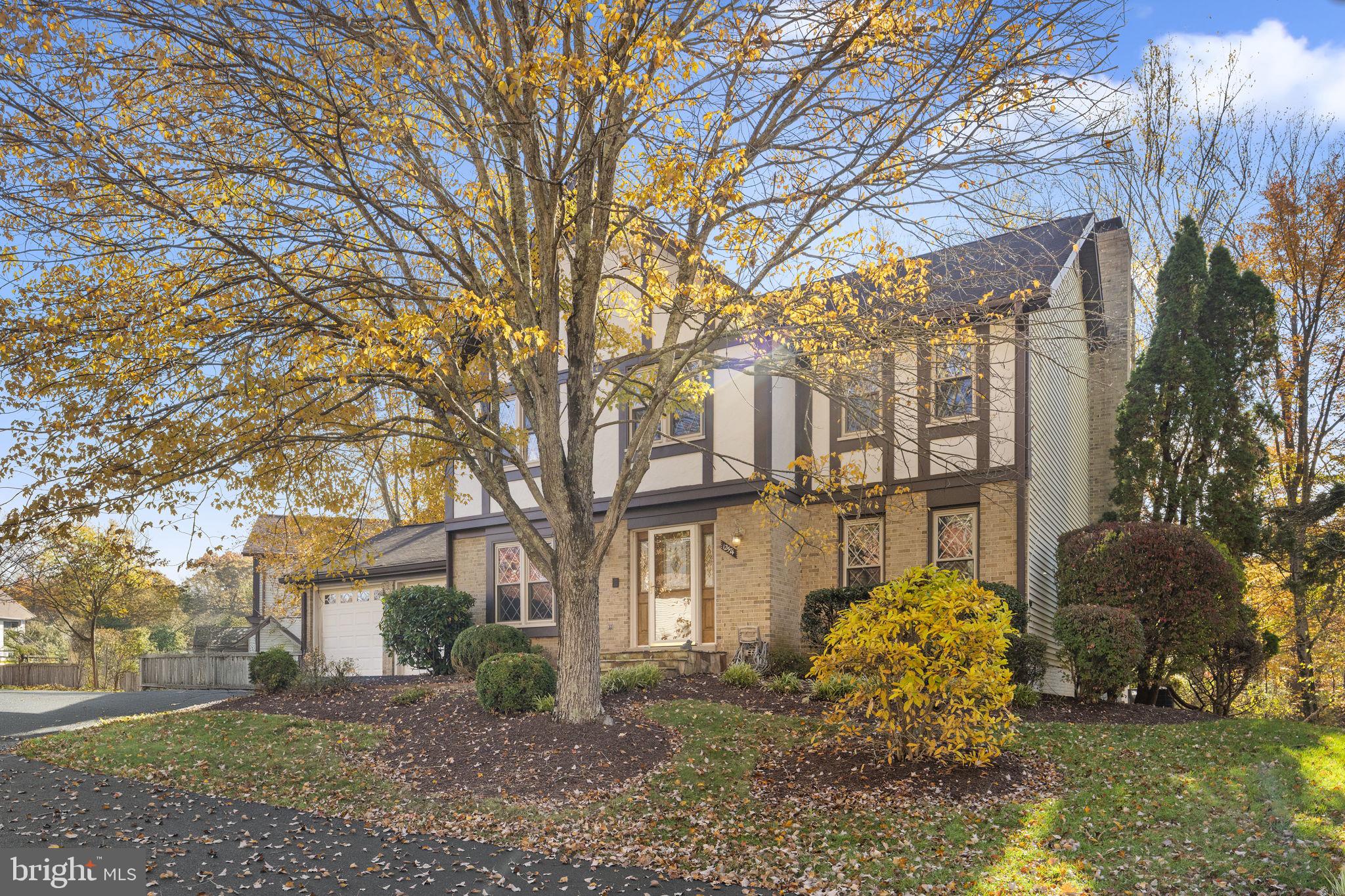 12574 Quincy Adams Court Herndon, VA 20171 - Photo 1 of 67 a front view of a house with a garden and trees