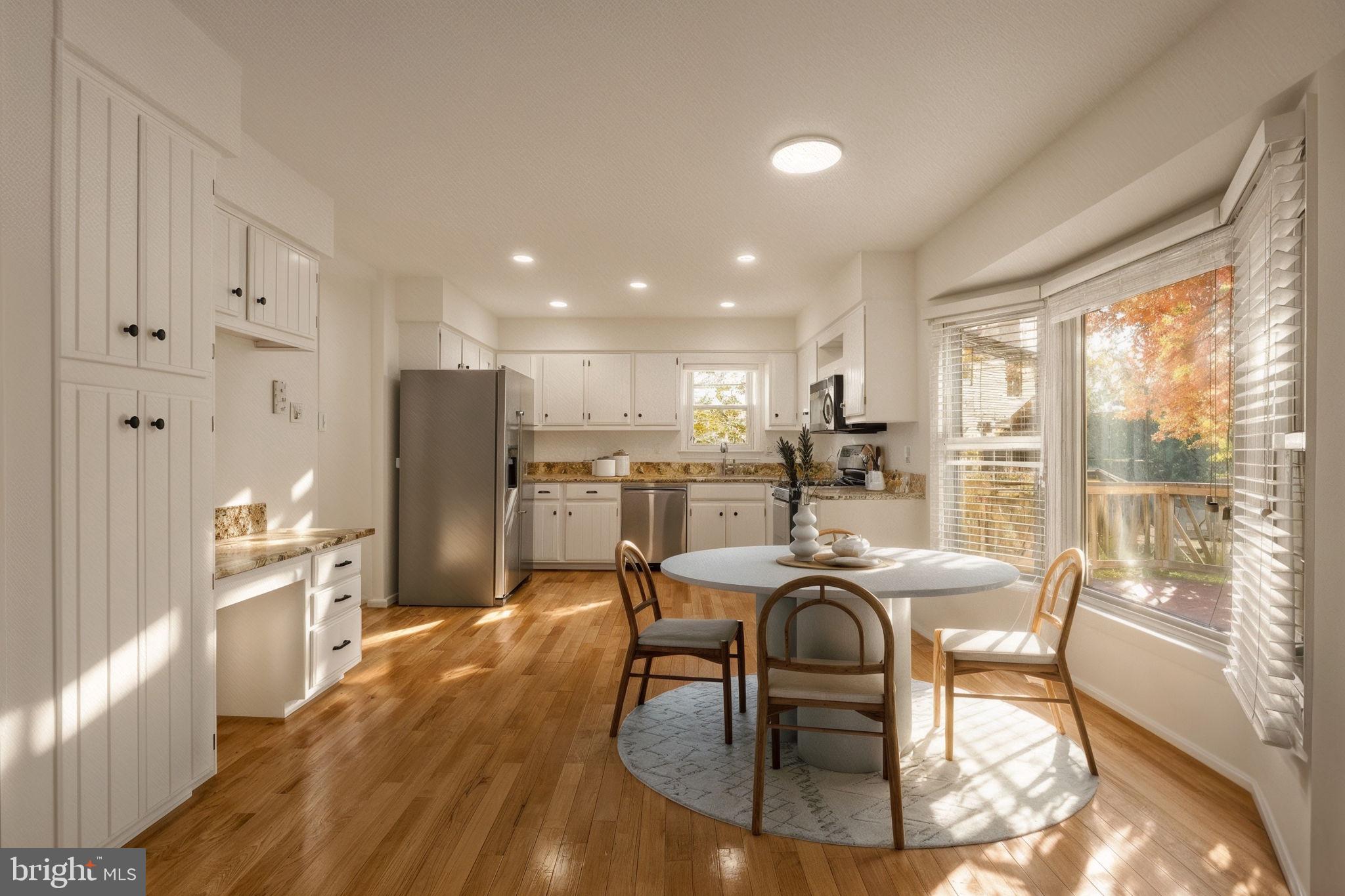 12574 Quincy Adams Court Herndon, VA 20171 - Photo 14 of 67 a dining room with stainless steel appliances granite countertop a stove top oven a dining table and chairs