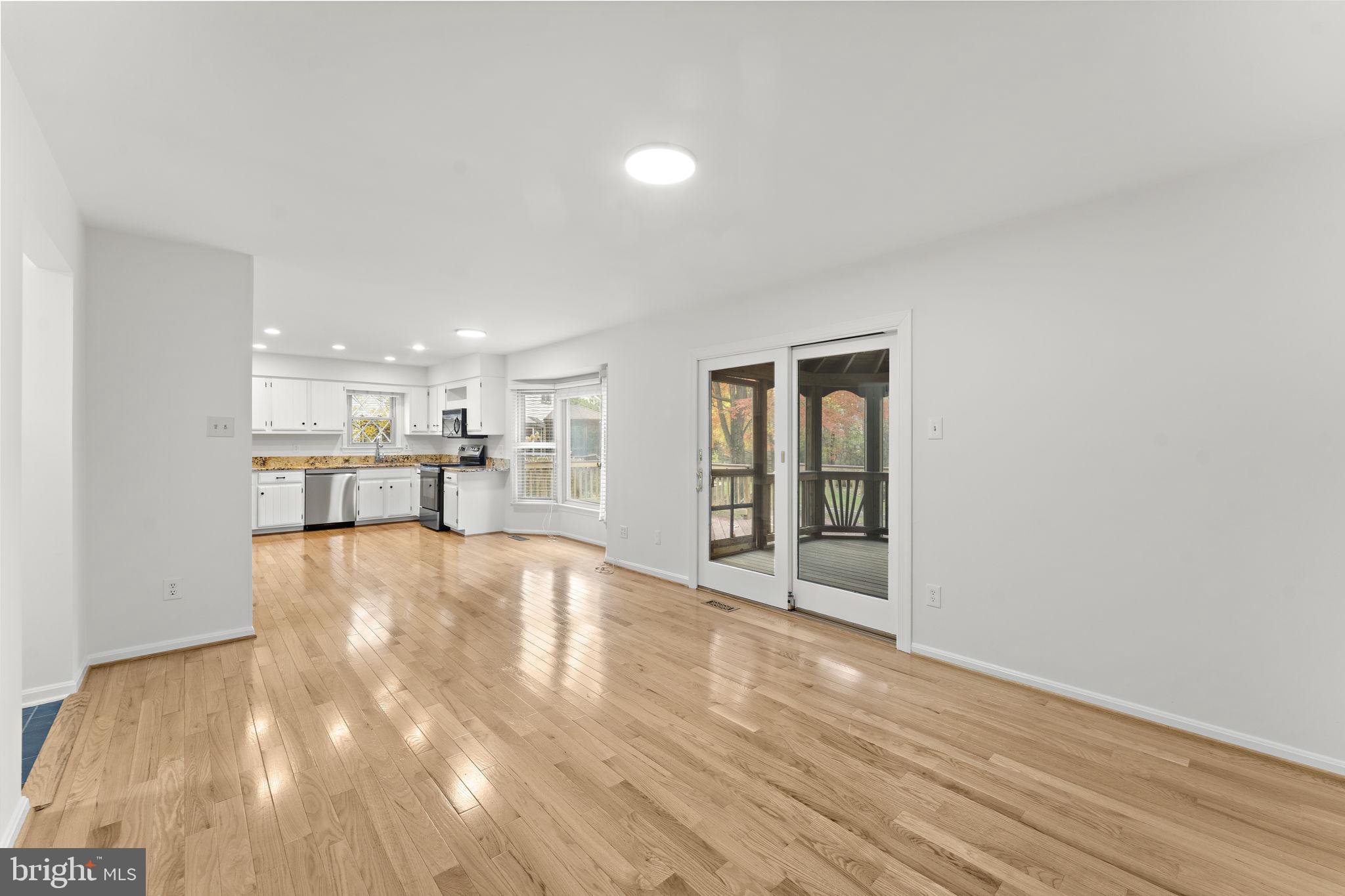 12574 Quincy Adams Court Herndon, VA 20171 - Photo 15 of 67 a view of a kitchen with wooden floor and a window
