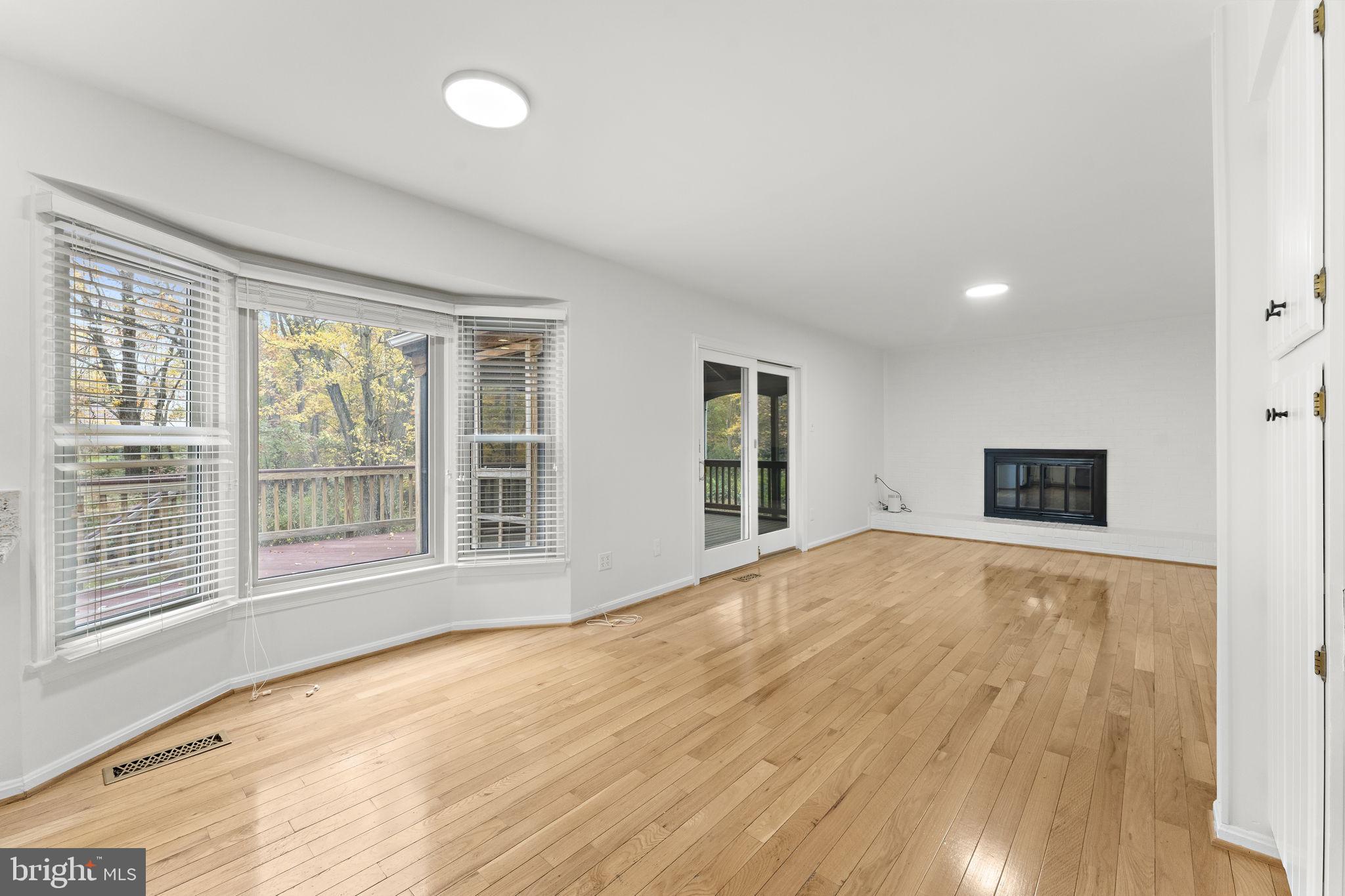 12574 Quincy Adams Court Herndon, VA 20171 - Photo 18 of 67 a view of an empty room with a window and wooden floor